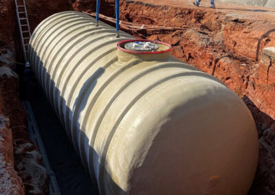 Fuel storage tank being installed in an excavation