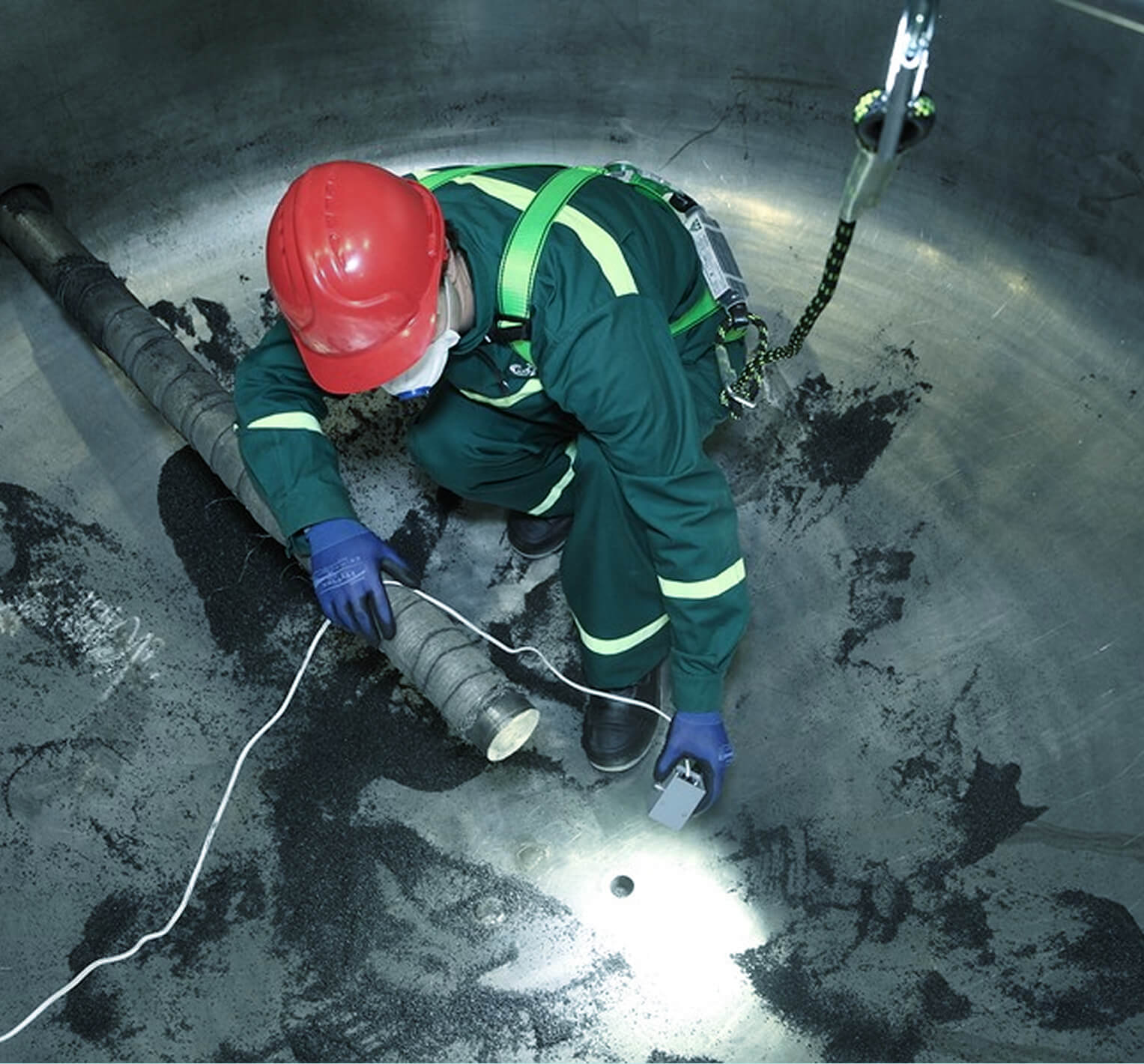 Technician inspecting the inside of a fuel storage tank